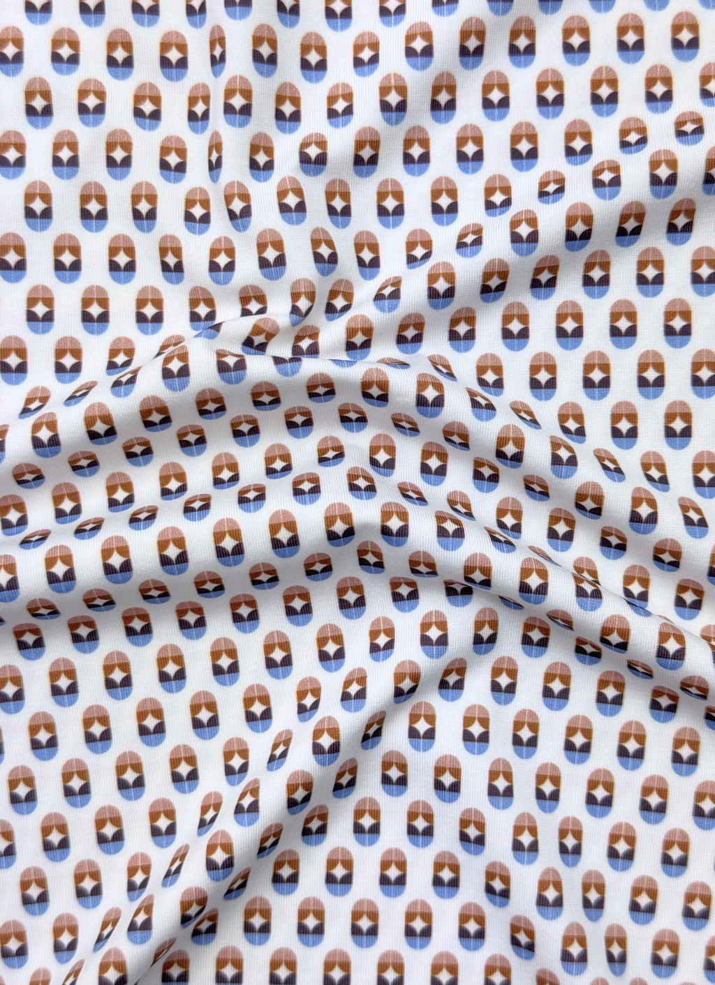 Printed Stretch Polo — Blue & Brown Pill Pattern, Buttery Smooth Fabric, Metal-Rimmed Buttons