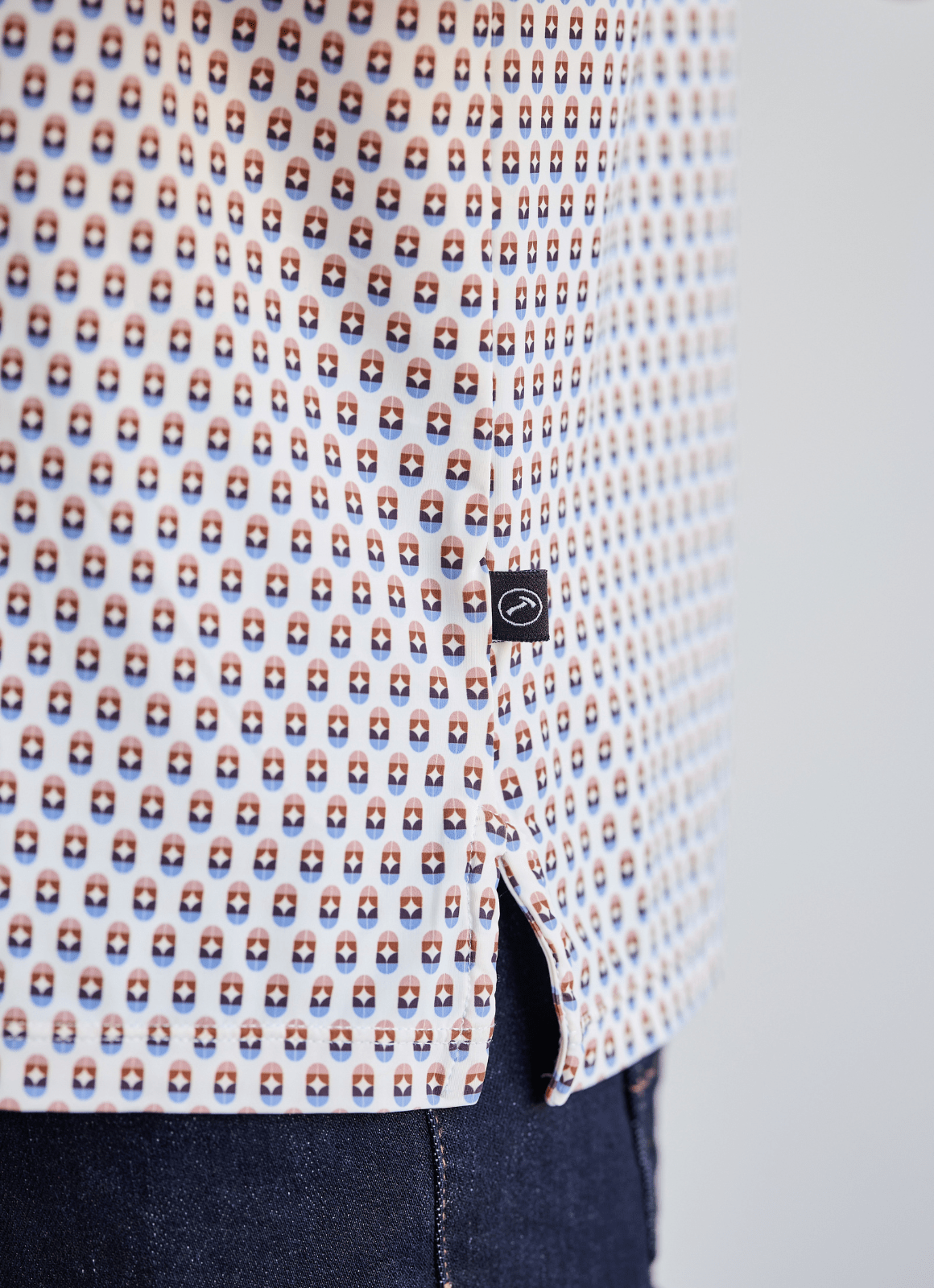 Printed Stretch Polo — Blue & Brown Pill Pattern, Buttery Smooth Fabric, Metal-Rimmed Buttons