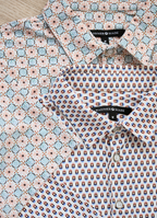 Printed Stretch Polo — Blue & Brown Pill Pattern, Buttery Smooth Fabric, Metal-Rimmed Buttons